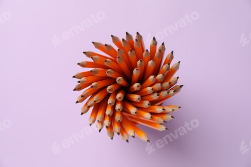 Preview: Many graphite pencils in holder on violet background, top view