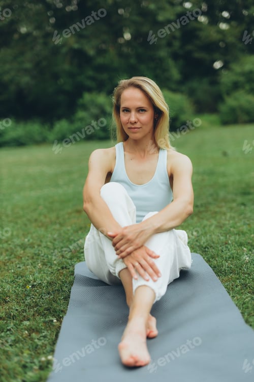Preview: young woman athlete in sportswear practices yoga, enjoys training
