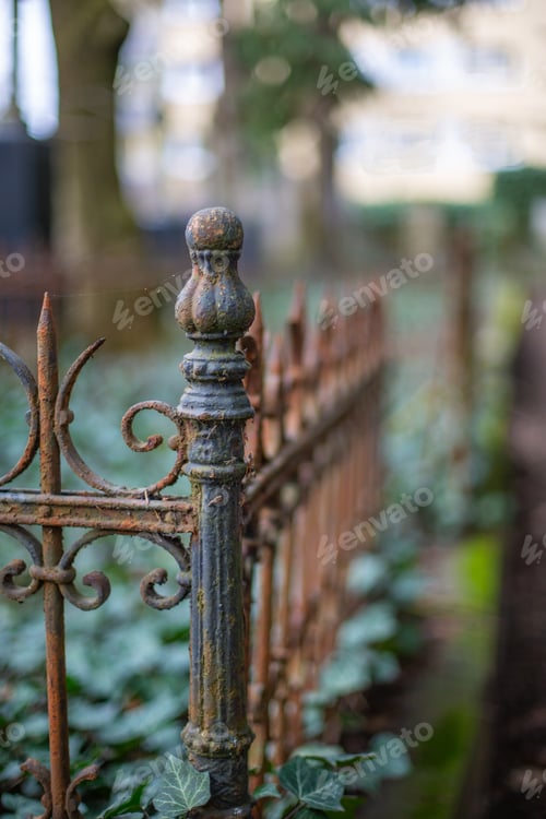 Preview: Old rusty fence on a graveyard with a blurry background