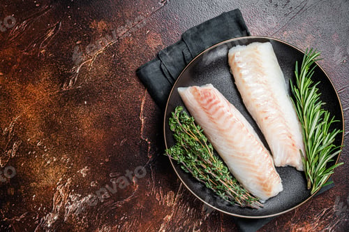 Preview: Raw cod loin fillet steaks with herbs on plate. Dark background. Top view. Copy space