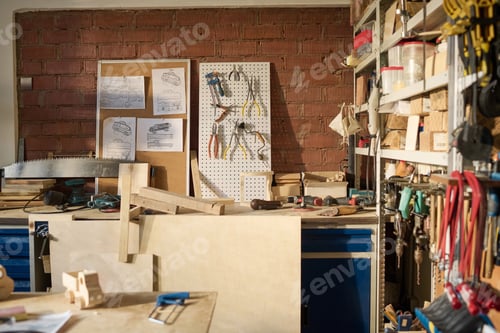 Preview: Carpentry Workshop with Tools and Wooden Models on Table