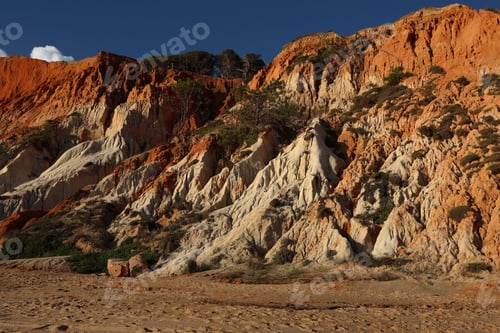 Preview: Stunning orange and white cliffs under a blue sky.
