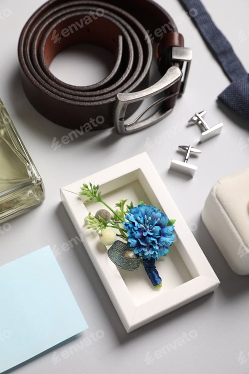 Preview: Wedding stuff. Composition with stylish boutonniere on light gray background, above view
