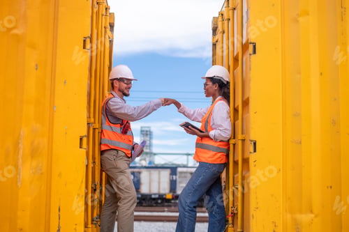 Preview: Engineers railway survey wearing safety uniform and helmet under conversation document on hand inspe