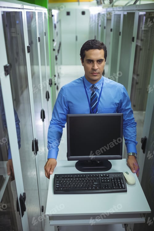 Preview: Technician Walking With Personal Computer In Hallway Of Server Room