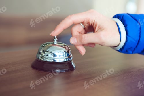 Preview: Hand of a woman using a hotel bell