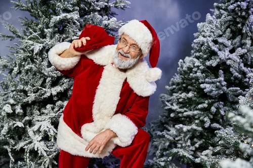 Preview: Santa Claus joyfully poses in a snowy forest, spreading holiday cheer with his cheerful presence