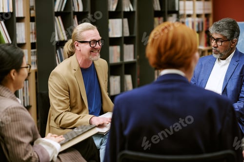 Preview: Diverse Men and Women Discussing Book during Presentation in Library
