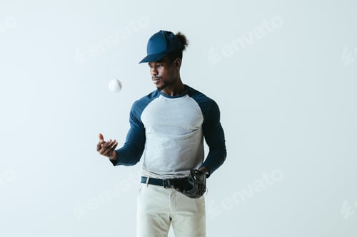 Preview: handsome african american sportsman with baseball glove and ball isolated on grey