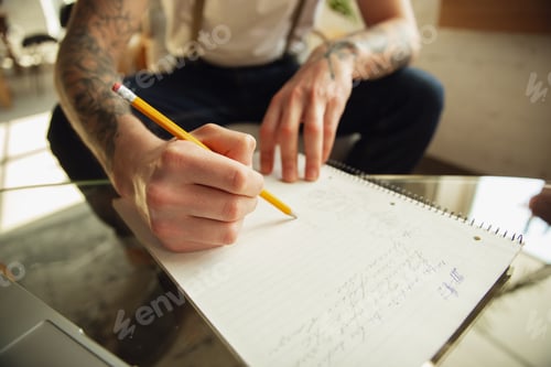 Preview: Close up of male hands writing on an empty paper, education and business concept