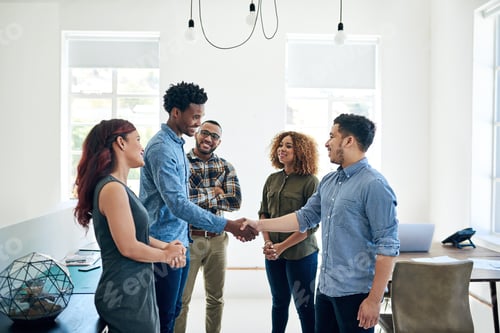 Preview: Growing business with a great new deal. Shot of happy colleagues shaking hands in a modern office.