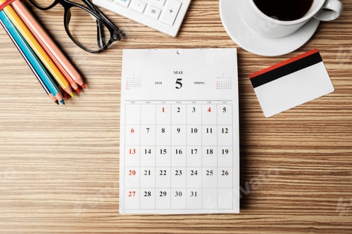 Preview: Work desk setup with calendar, colored pencils, cup of coffee, and keyboard