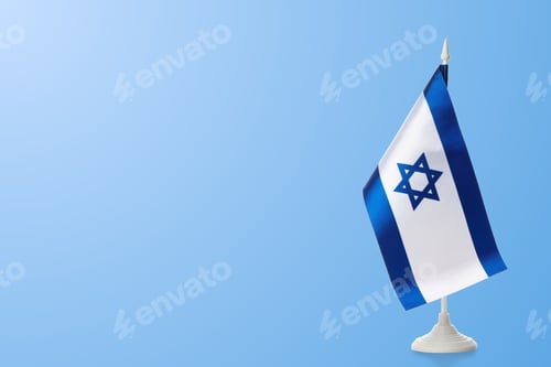 Preview: Israeli flag on a stand against light blue background
