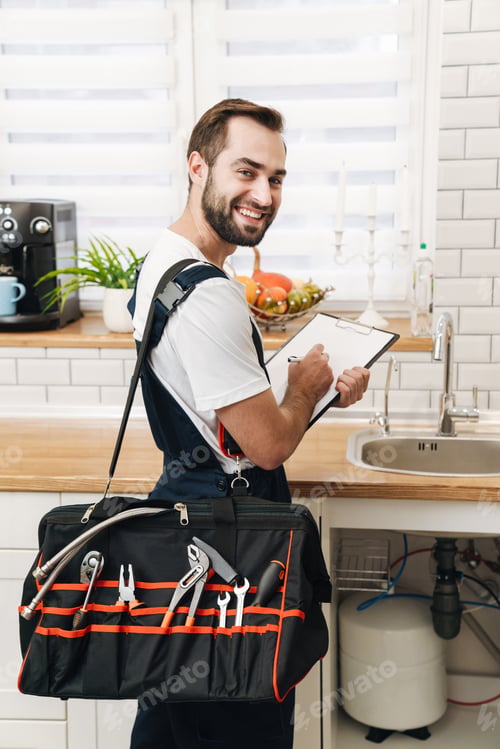 Preview: Image of plumber man with equipment and clipboard working in apartment