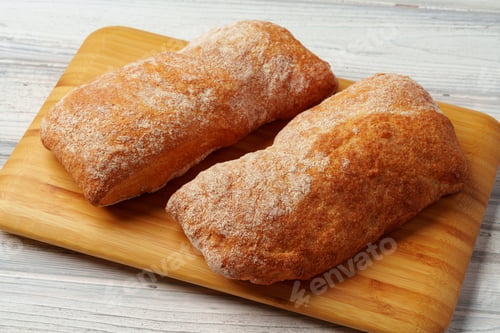 Preview: Two bread buns on wooden board close up