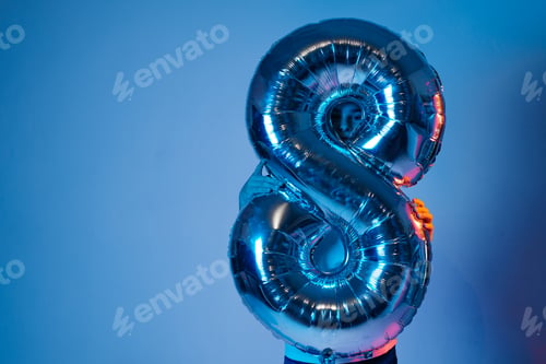 Preview: Inflatable ball eight in neon light holds a boy