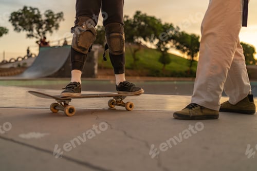 Preview: Boy learning to skate with his coach at the skate park