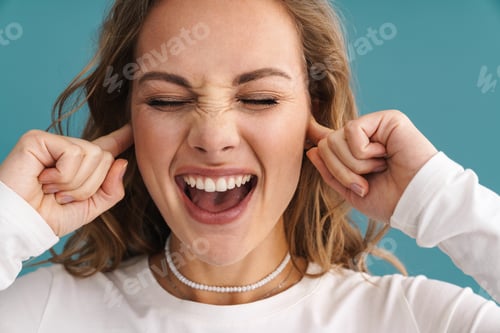 Preview: Blonde happy woman plugging her ears and laughing