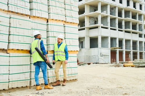 Preview: Construction engineers speaking near materials