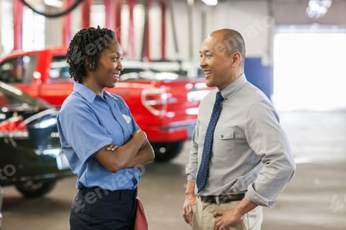 Preview: Male Pacific Islander auto repair shop manager talks to female Hispanic mechanic