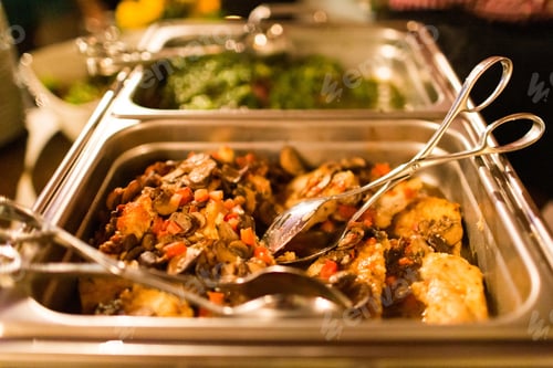 Preview: Closeup shot of a delicious dish with mushrooms and potatoes and a serving spoon in it