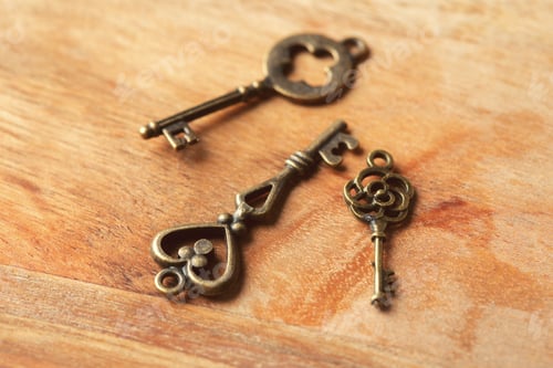 Preview: Unique antique keys displayed on wooden surface showcasing intricate designs and craftsmanship