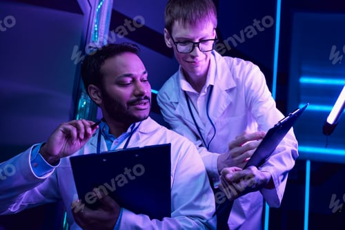 Preview: Futuristic Analysis: Hindu Scientist Examines Data in Neon-Lit Science Center