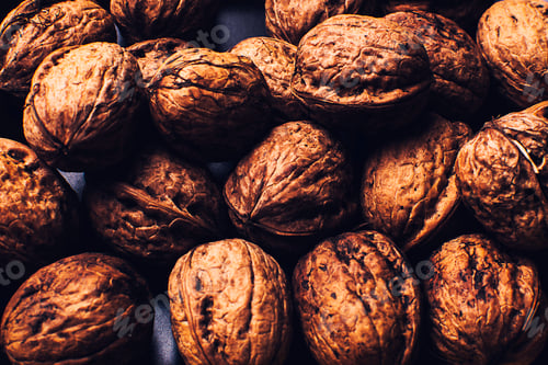 Preview: Black flat plate full of nuts that occupy the entire image.