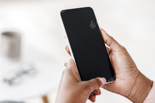 Preview: Mockup of smartphone with black screen in hands of unrecognizable black woman
