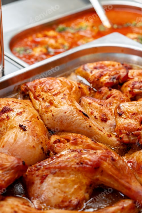 Preview: Metal tray with fresh baked chicken in a canteen