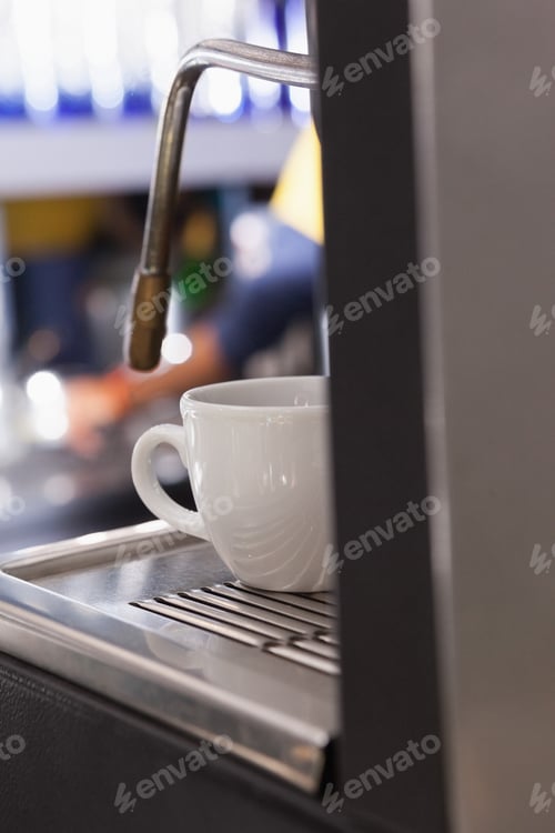 Preview: Cup of coffee on the espresso maker at the coffee shop