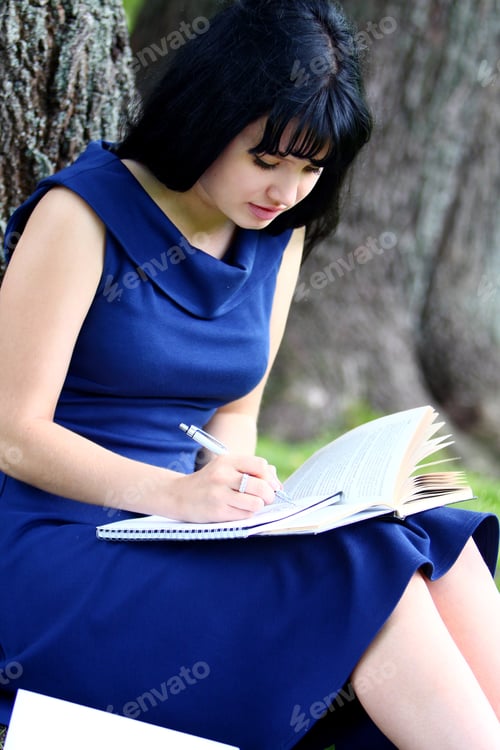 Preview: Beautiful girl studying in park