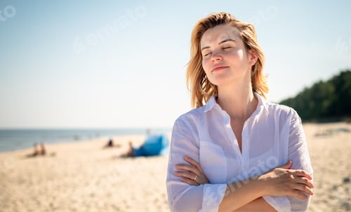 Preview: Portrait of natural young woman walking on sandy beach at sunny day