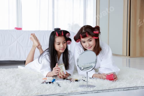 Preview: Girl and Woman with Hair Rollers Relaxing Indoors