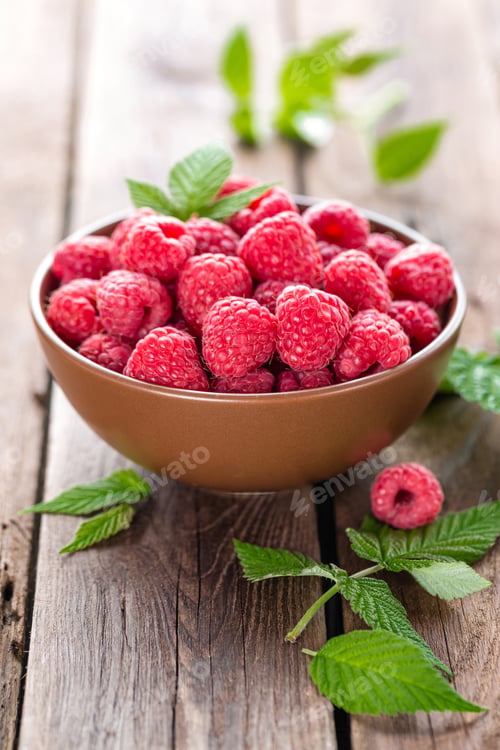 Bowl of Fresh Raspberries on Rustic Wood Table