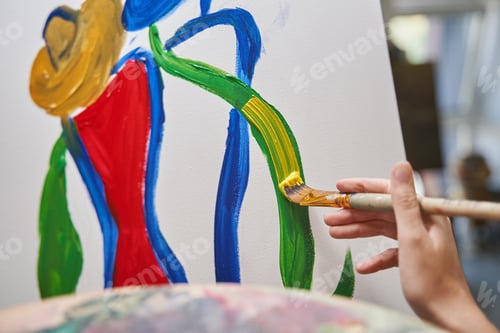 Preview: Focused photo on female artist painting with oil colors