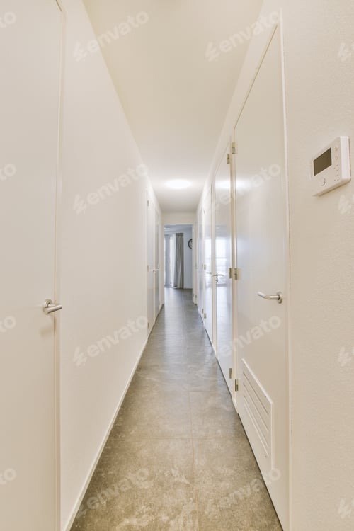 Preview: A long straight corridor in white with many doors