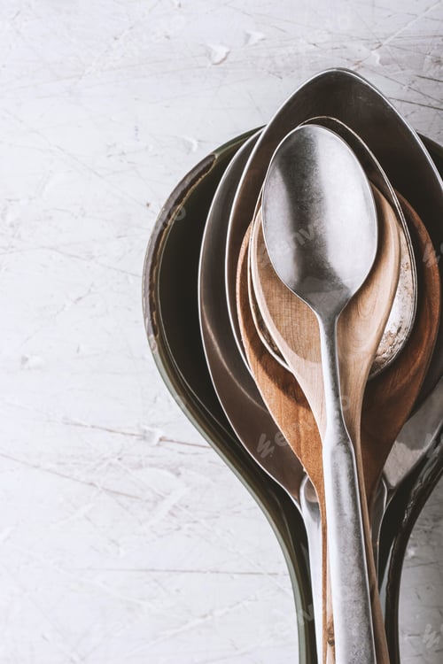 Preview: Different spoons on the white table vertical