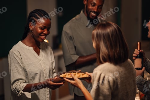 Preview: Friends sharing pie and wine at thanksgiving celebration