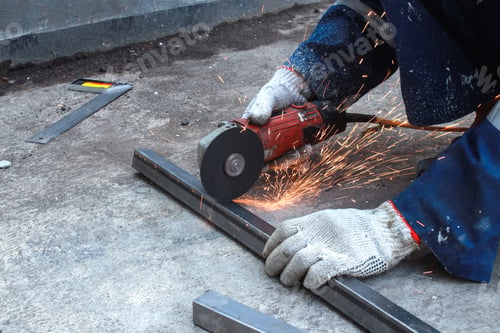Preview: Worker Cutting Metal Bar Using Grinder