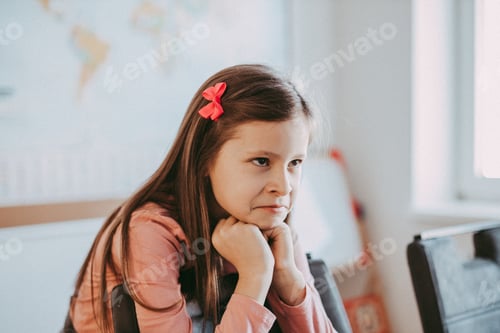 Preview: Contemplative Girl Leans on Hands Indoors