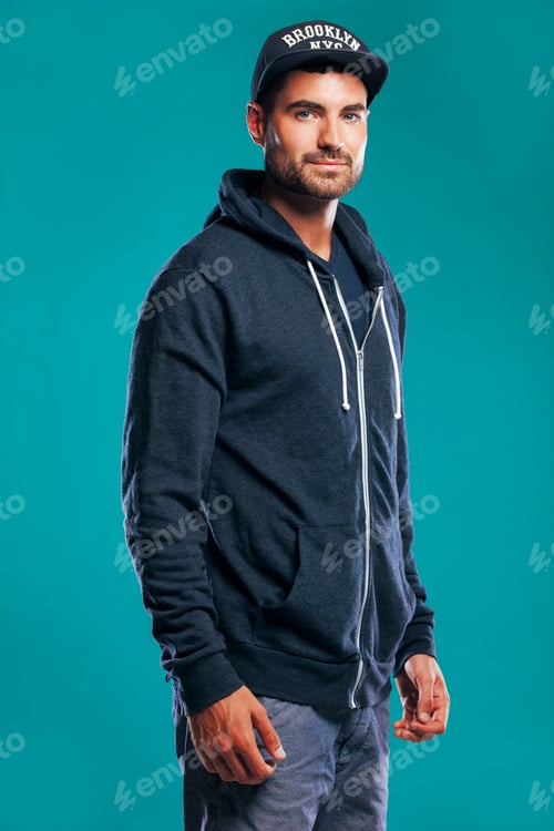Preview: Stylish young man in cap and hoodie