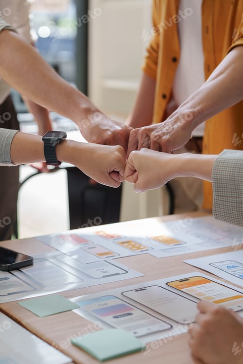 Preview: Team making fist bump for successful collaboration