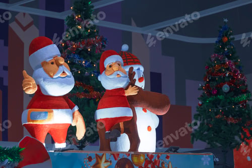 Preview: 2 Santa Claus dolls and Christmas decorations display in shopping mall during Christmas festival