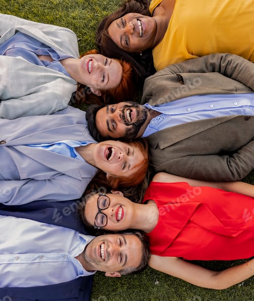 Preview: Diverse Business Team Lying on Grass in a Team-Building Activity