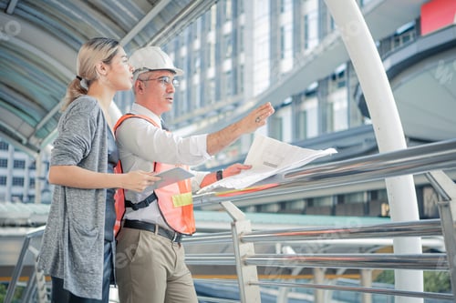 Preview: Senior engineers describe the details of the project to young woman customers.