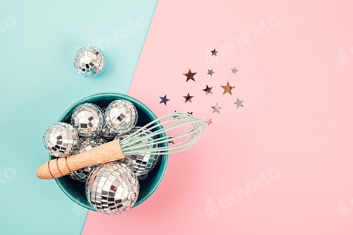 Preview: Flat lay with disco balls in the bowl with whisk. Party, fun, celebration planning