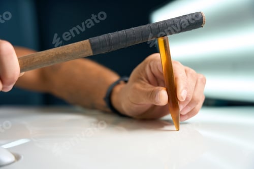 Preview: Using a special gadget to level out body dents