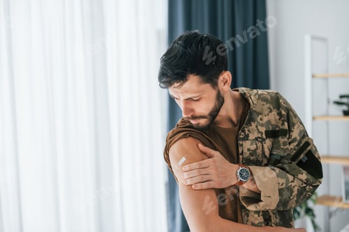 Preview: Getting vaccinated. Soldier in uniform is indoors in the domestic room