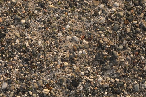 Preview: background of pebbles on the beach. Stone gravel texture.stone background or wallpaper. pebble beach